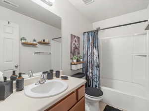 Bathroom with vanity and shower / bathtub combination with curtain