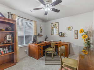 Bedroom or Office with ceiling fan and light carpet