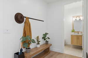 Hallway with light wood-type flooring and baseboards