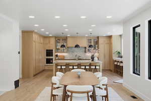 Dining area featuring light wood-style flooring and recessed lighting