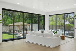 Living room featuring light wood-type flooring and recessed lighting
