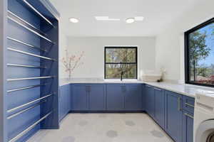 Laundry room with washer / dryer, cabinet space, light flooring, and recessed lighting