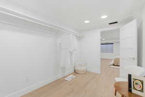 Walk in closet featuring light wood finished floors