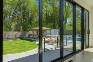 Entryway with wood finished floors and view of wooded area