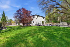 Back of house featuring a patio, a gazebo, and stucco siding