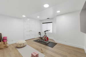 Workout room featuring light wood-style flooring and recessed lighting