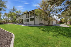Rear view of property featuring a patio, a balcony, stucco siding, and entry steps