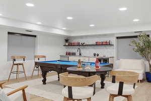 Recreation room featuring pool table, wet bar, recessed lighting, light wood-type flooring, and beverage cooler