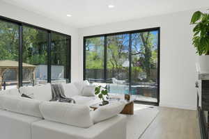 Living room featuring light wood-style floors and recessed lighting