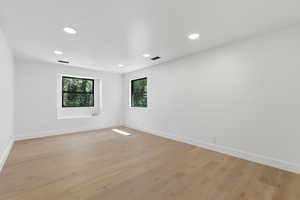 Unfurnished room featuring light wood-type flooring and recessed lighting