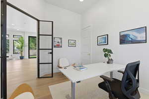 Office featuring light wood-style flooring and recessed lighting