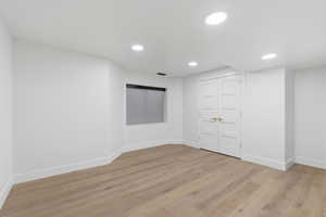 Unfurnished room with light wood-type flooring and recessed lighting