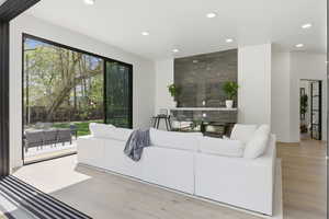 Living room with recessed lighting and light wood-style flooring
