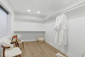 Walk in closet featuring light wood finished floors
