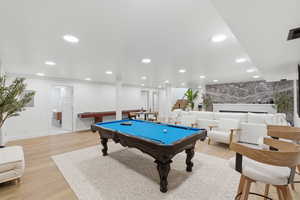 Recreation room with recessed lighting, light wood finished floors, billiards, and an accent wall