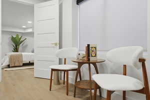 Sitting room with light wood-style flooring and recessed lighting