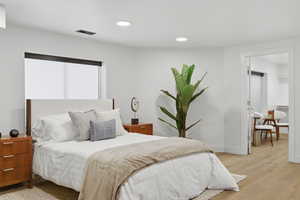 Bedroom with light wood-style floors and recessed lighting
