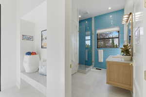 Full bathroom with vanity, a shower stall, recessed lighting, and light tile patterned floors