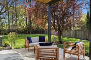 Fenced backyard featuring outdoor furniture and a patio