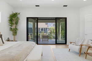 Bedroom featuring light wood-type flooring, access to exterior, and recessed lighting