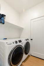 Large laundry room with large capacity new washer and dryer, included.