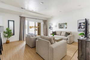 Spacious living room with glass sliders to large patio with hot tub.