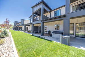 Modern exterior featuring board and batten siding and multiple balconies