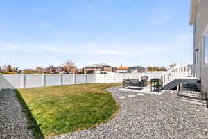 Fully fenced landscaped backyard featuring a patio