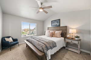 Primary bedroom featuring vaulted ceiling