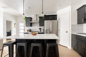 View of kitchen and 1/2 bathroom by the front door.