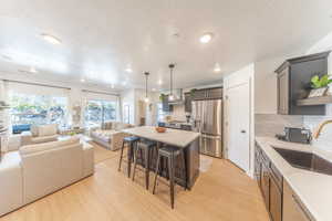 Kitchen and living area with large windows. Fully stocked, furnished and decorated.