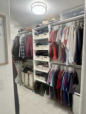 Walk in closet featuring light tile patterned floors