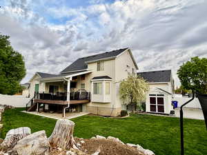 Back of property featuring a fenced backyard, a storage shed, roof with shingles, and a wooden deck