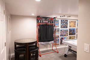 Game room with recessed lighting and light carpet