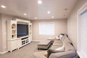 Living room featuring recessed lighting and light carpet