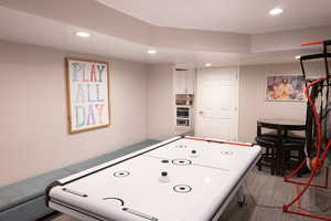 Playroom with recessed lighting and carpet