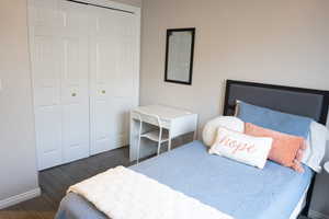 Bedroom featuring dark carpet and a closet