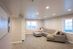 Living room with recessed lighting and light carpet