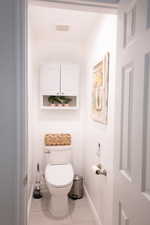 Bathroom featuring toilet and light tile patterned flooring