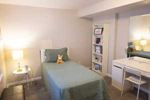 Bedroom featuring dark carpet