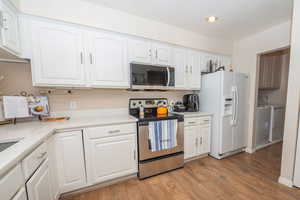 Kitchen showing access into laundry room. Fridge included.