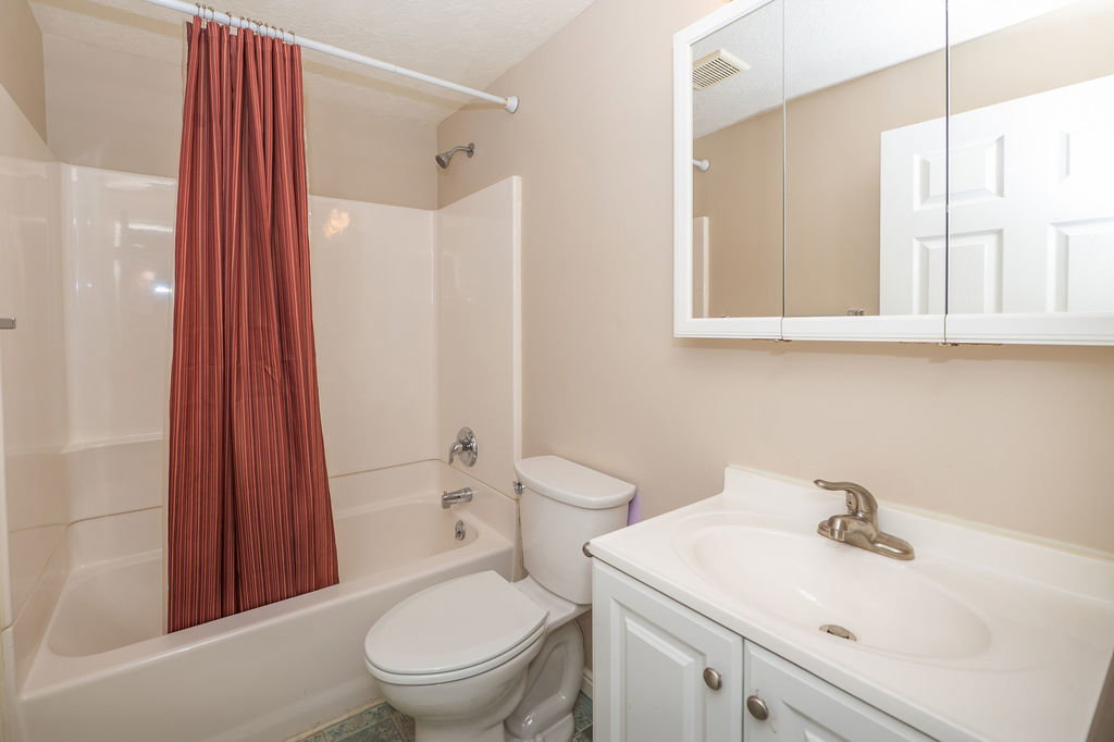 Full bathroom with shower / bath combo.
