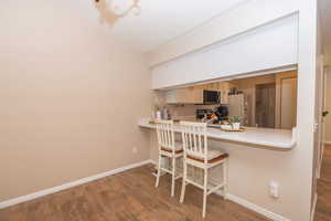 Breakfast bar between kitchen and dining area.