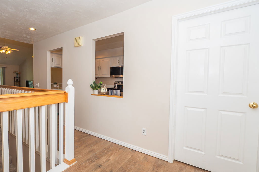 Entry way, looking toward the kitchen. The door goes into the laundry room, also accessible through the kitchen.