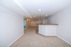 Family room with wet bar and recessed lighting.