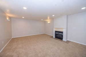 Living room with a fireplace and recessed lighting.