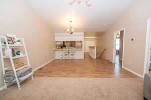 Dining area with hanging lights and lofted ceiling.