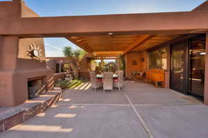 View of patio / terrace featuring an outdoor fireplace and outdoor dining area
