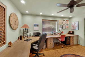 Office with light wood finished floors, ceiling fan, and recessed lighting