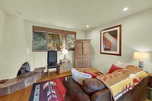 Living area featuring wood finished floors and recessed lighting